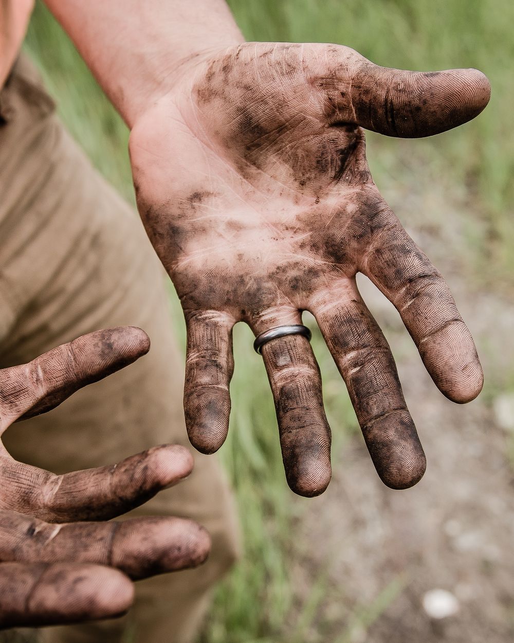 Hands covered in dirt after a day of yard work