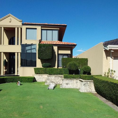 Large front lawn in front of a two storey home